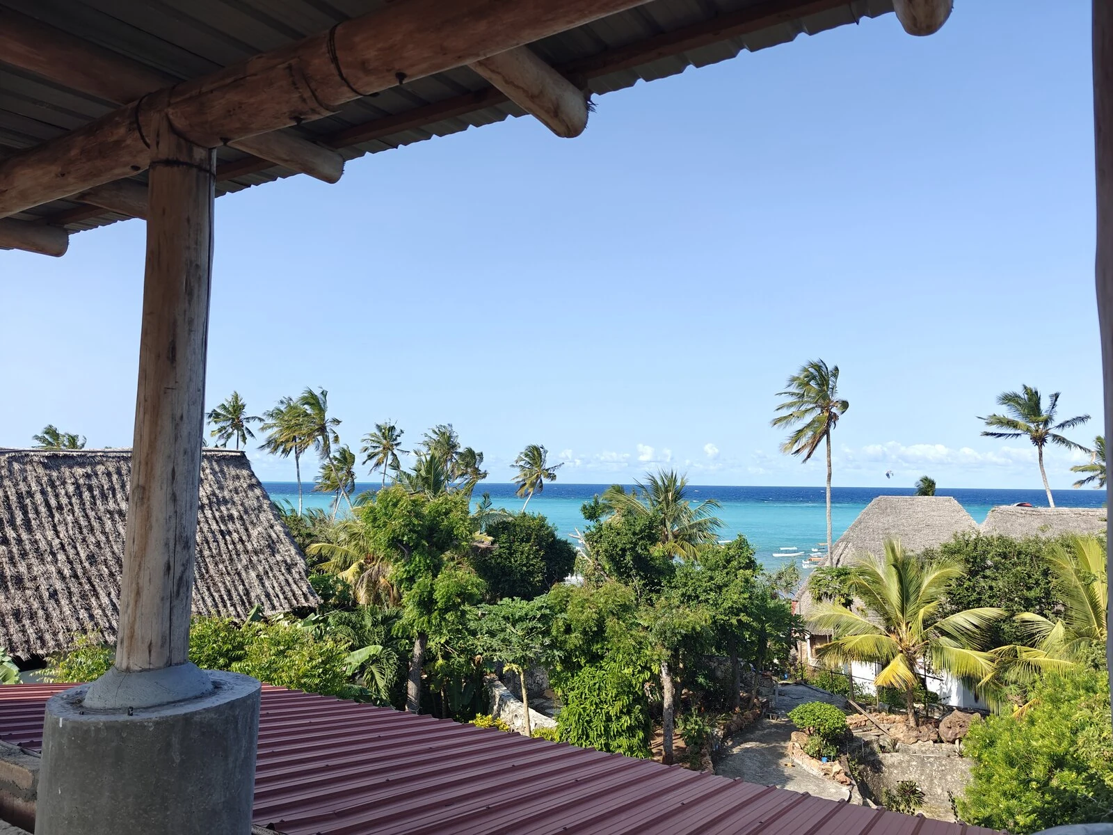 A covered terrace under thatch looking out to the sea at Cheche Vule.